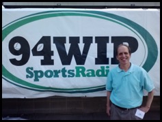 Joel in Front of WIP Sports Radio Sign 2014